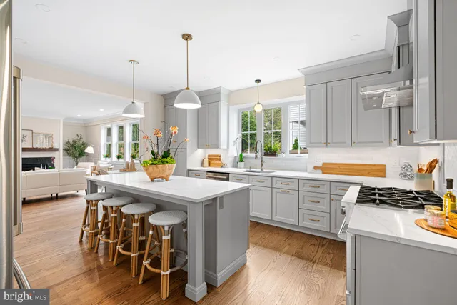 a kitchen with stainless steel appliances kitchen island granite countertop a stove a sink and a refrigerator