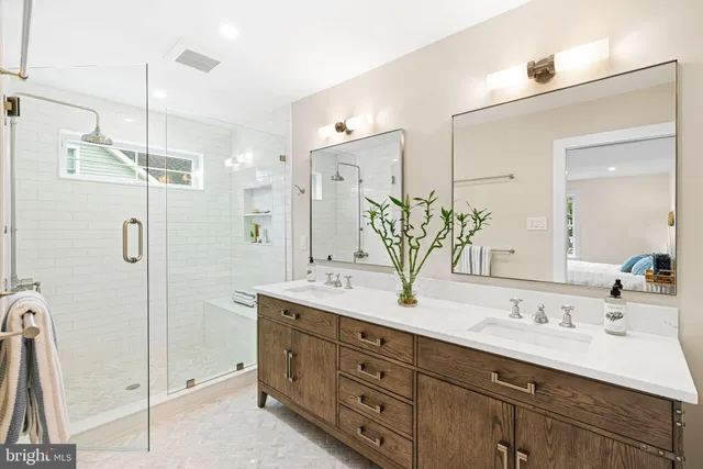 a kitchen with stainless steel appliances kitchen island granite countertop a refrigerator and a sink