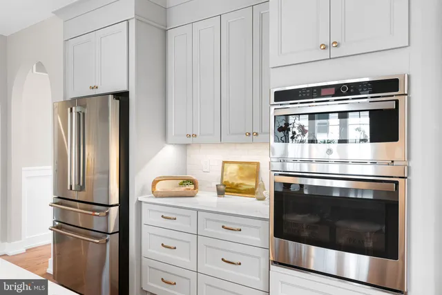a living room with fireplace furniture and a large window