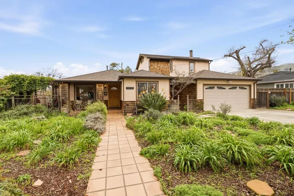 a front view of a house with a garden