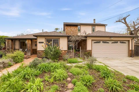 a front view of a house with garden