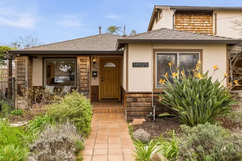 a view of front door of house with outdoor seating
