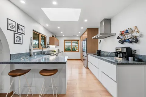 a kitchen with a sink and a refrigerator