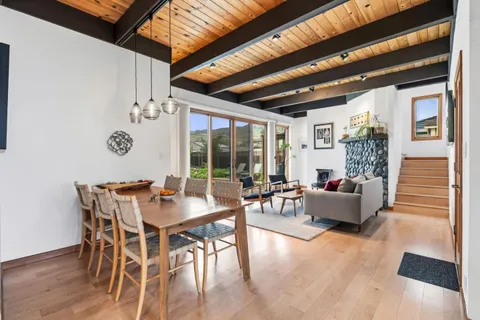 a living room with furniture and a floor to ceiling window