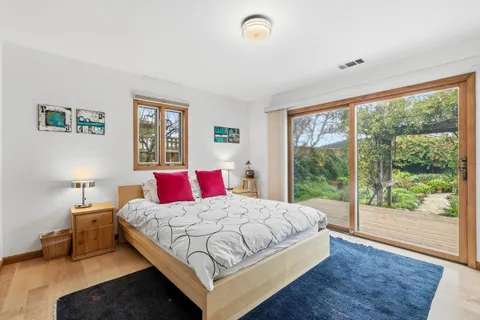 a bedroom with a bed and a large window