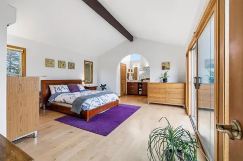 a bedroom with a large bed and a large window