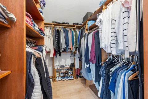 a view of a balcony with wooden floor and fence