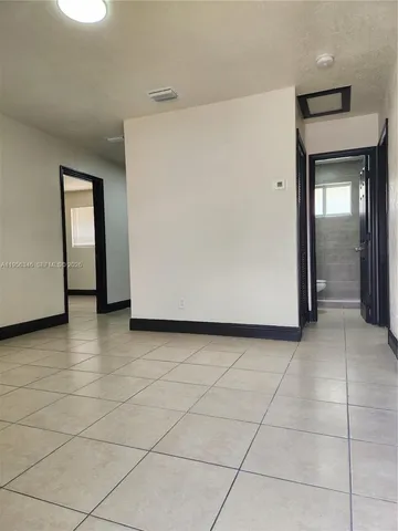 a view of a livingroom with an empty space and a window