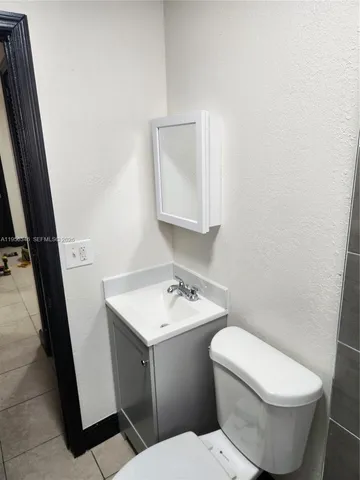 a white toilet sitting next to a bathroom sink