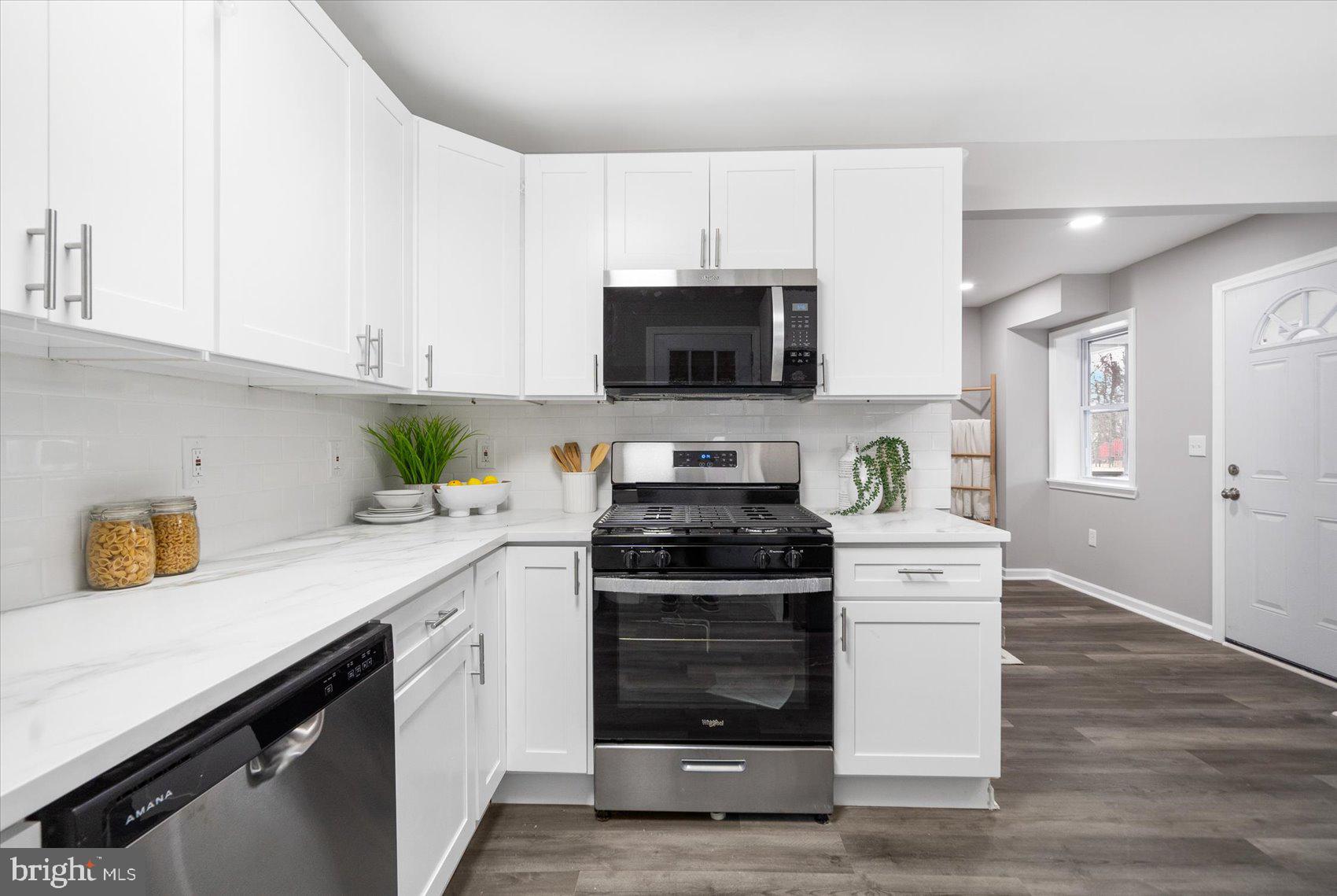 512 Meadow Road Baltimore, MD 21206 - Photo 14 of 41 a kitchen with a sink stove and microwave