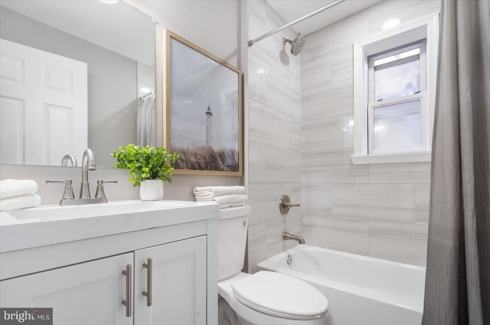 512 Meadow Road Baltimore, MD 21206 - Photo 16 of 41 a bathroom with a sink a toilet and shower