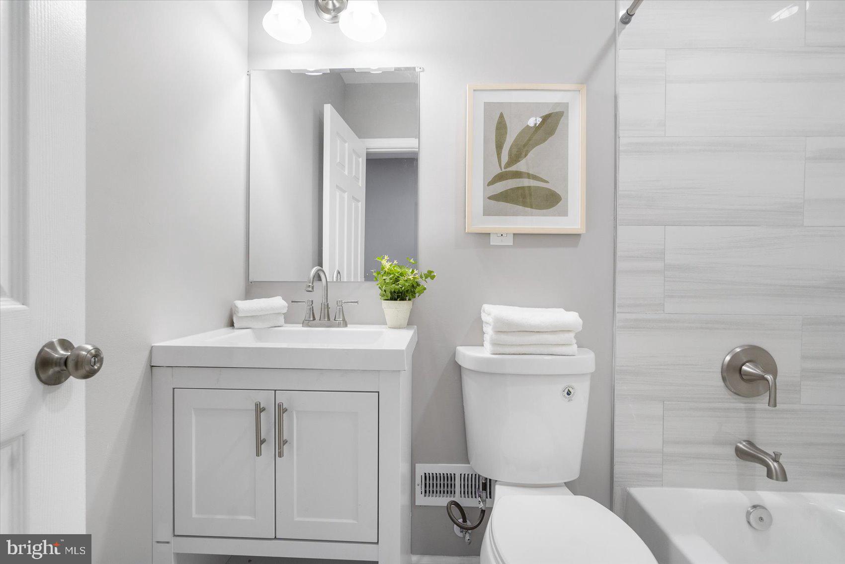 512 Meadow Road Baltimore, MD 21206 - Photo 25 of 41 a bathroom with a sink a toilet and mirror