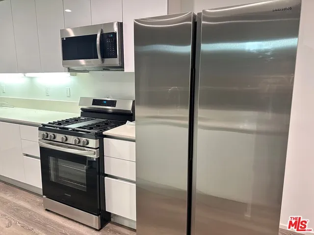a kitchen with a refrigerator stove and microwave