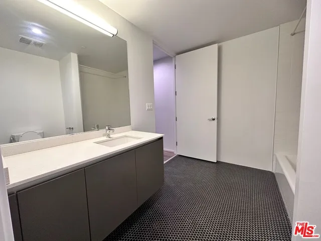 a bathroom with a double vanity sink and mirror
