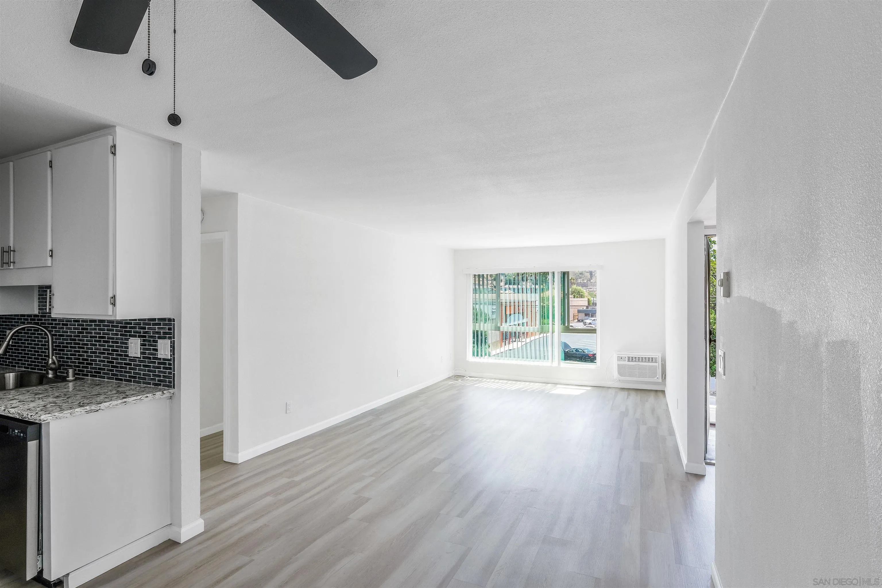 3827 Conrad Drive Spring Valley, CA 91977 - Photo 5 of 9 a view of an empty room with wooden floor and a window