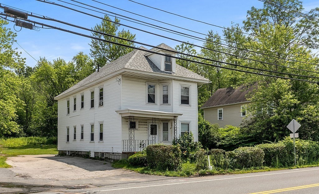 159-161 Howe Street Methuen, MA 01844 - Photo 1 of 15 a front view of a house with a garden