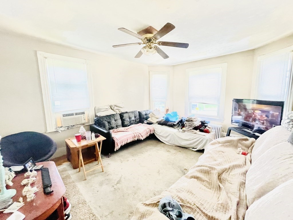 159-161 Howe Street Methuen, MA 01844 - Photo 12 of 15 a bedroom with furniture and a ceiling fan