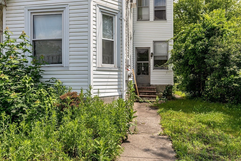 159-161 Howe Street Methuen, MA 01844 - Photo 13 of 15 a backyard of a house with plants and garden