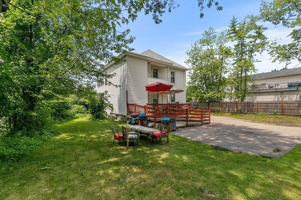 159-161 Howe Street Methuen, MA 01844 - Photo 3 of 15 a view of a house with backyard sitting area and garden