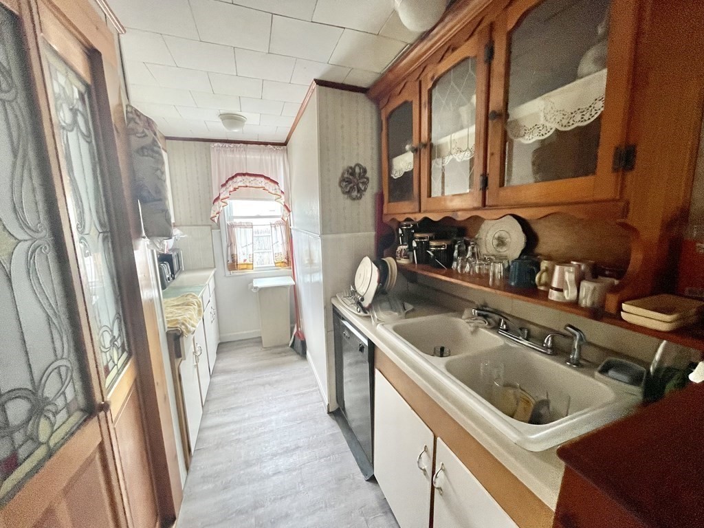 159-161 Howe Street Methuen, MA 01844 - Photo 6 of 15 a kitchen with a refrigerator and a sink