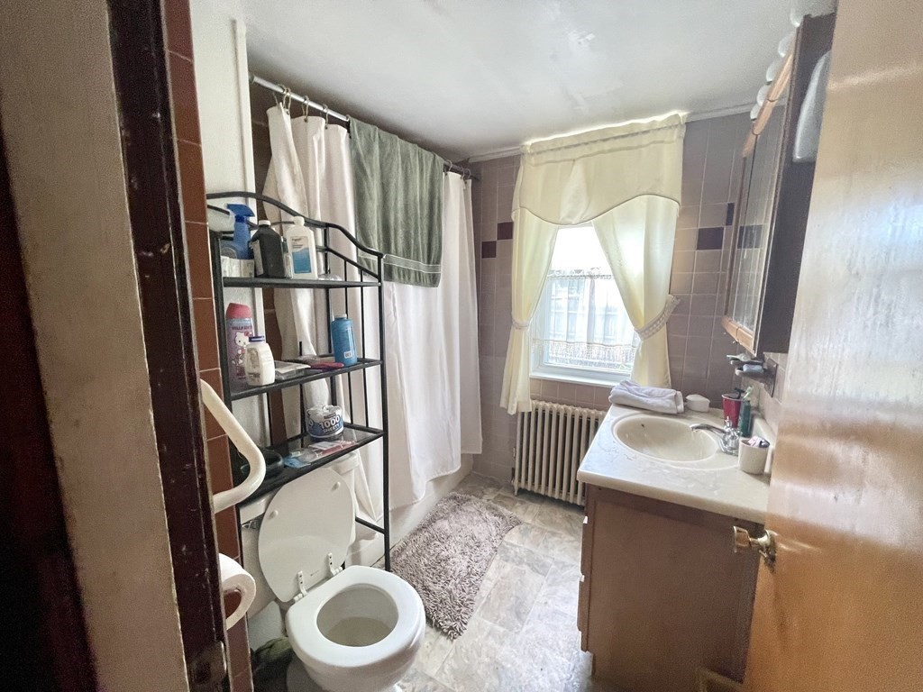 159-161 Howe Street Methuen, MA 01844 - Photo 10 of 15 a bathroom with a sink toilet and a mirror