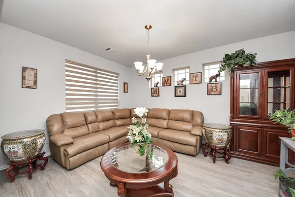 a living room with furniture chandelier and a window