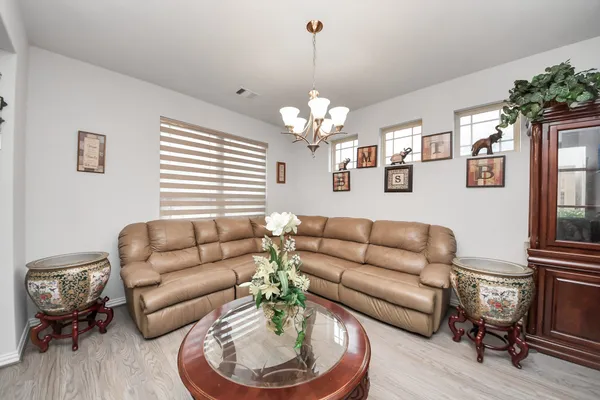 a living room with furniture and a chandelier