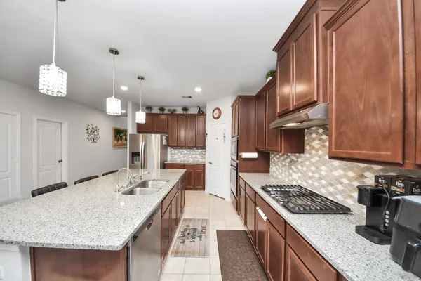 an open kitchen with a table and chairs