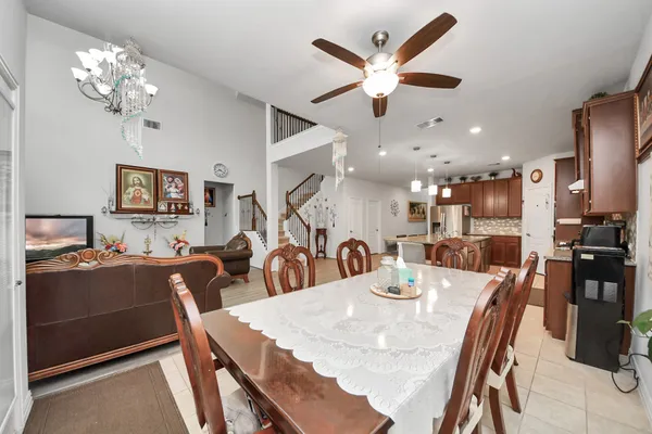 a living room with furniture chandelier and a flat screen tv