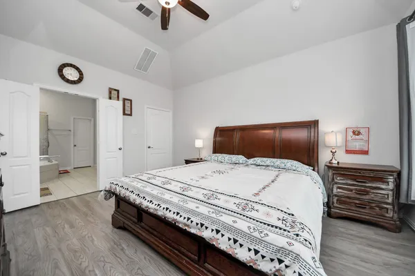 a bedroom with a bed and a dresser
