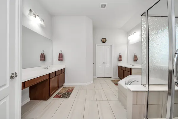 a spacious bathroom with a sink double vanity and a mirror