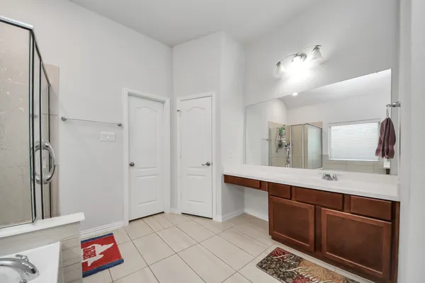 a white bath tub sitting in a bathroom next to a window
