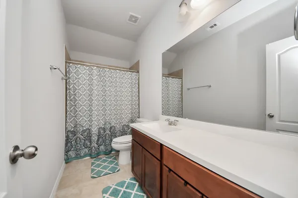 a bed room with a bed and a ceiling fan