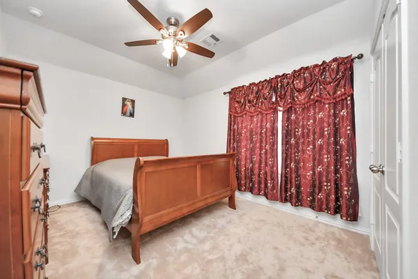 a bedroom with bed and window