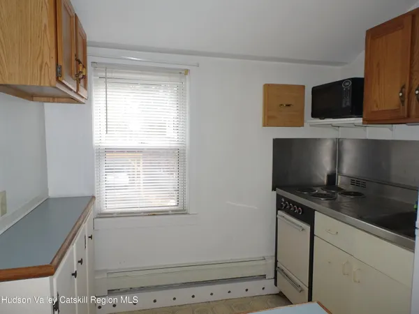 a room with a window and dresser