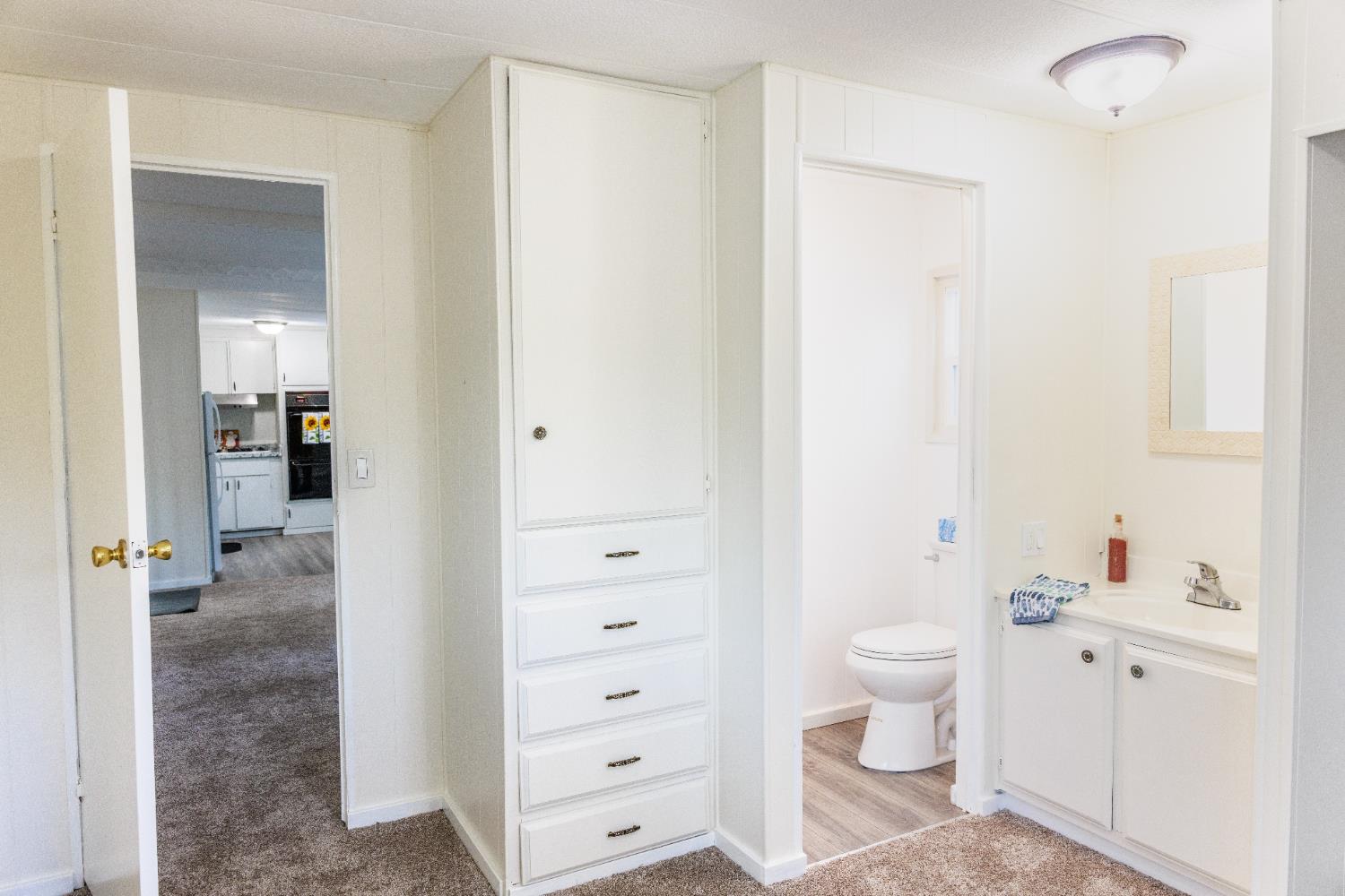 10251 Combie Road, Unit 13 Auburn, CA 95602 - Photo 13 of 16 a bathroom with a sink a toilet and shower