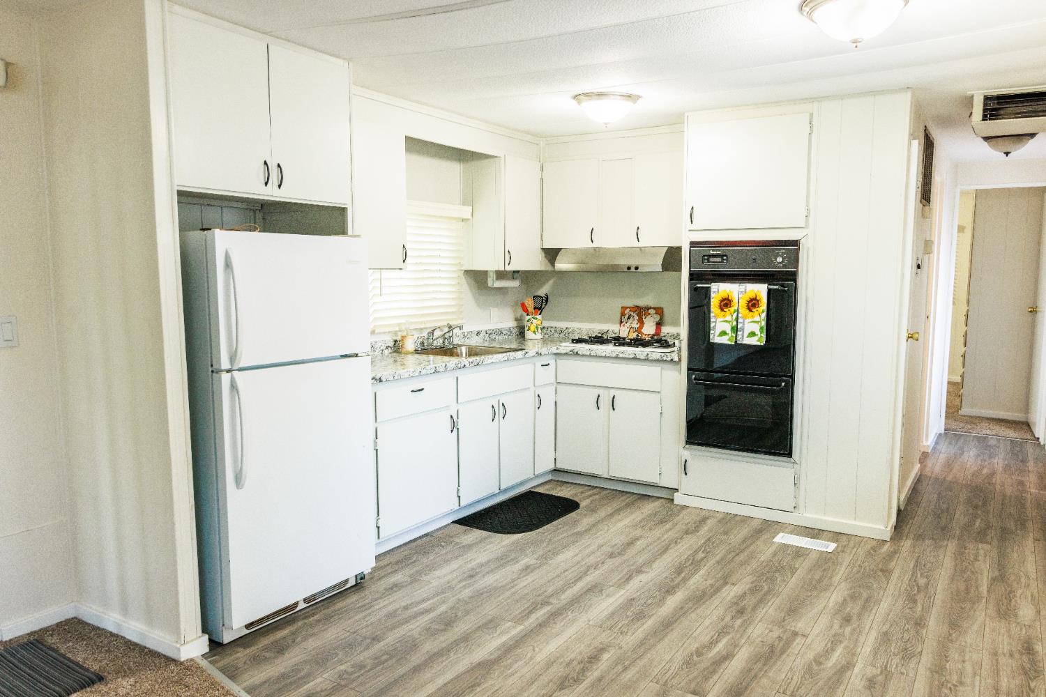10251 Combie Road, Unit 13 Auburn, CA 95602 - Photo 3 of 16 a kitchen with stainless steel appliances a refrigerator sink and cabinets