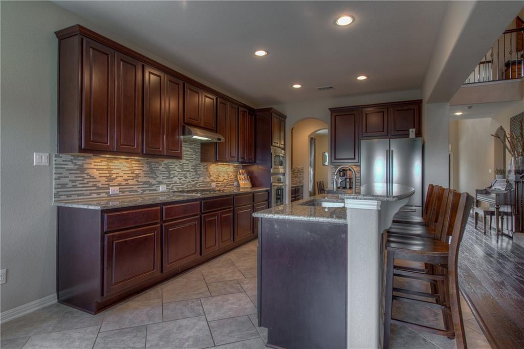 1511 Rimstone Drive Cedar Park, TX 78613 - Photo 14 of 40 a kitchen with lots of counter top space cabinets and appliances
