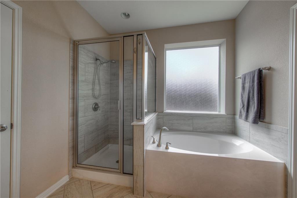 1511 Rimstone Drive Cedar Park, TX 78613 - Photo 19 of 40 a bathroom with a bathtub and a shower
