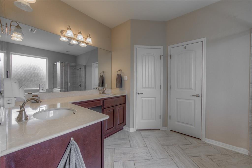 1511 Rimstone Drive Cedar Park, TX 78613 - Photo 20 of 40 a spacious bathroom with a granite countertop sink a mirror and a shower