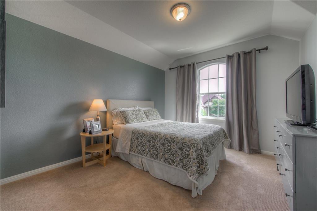 1511 Rimstone Drive Cedar Park, TX 78613 - Photo 28 of 40 a bedroom with bed and a flat tv screen on dresser