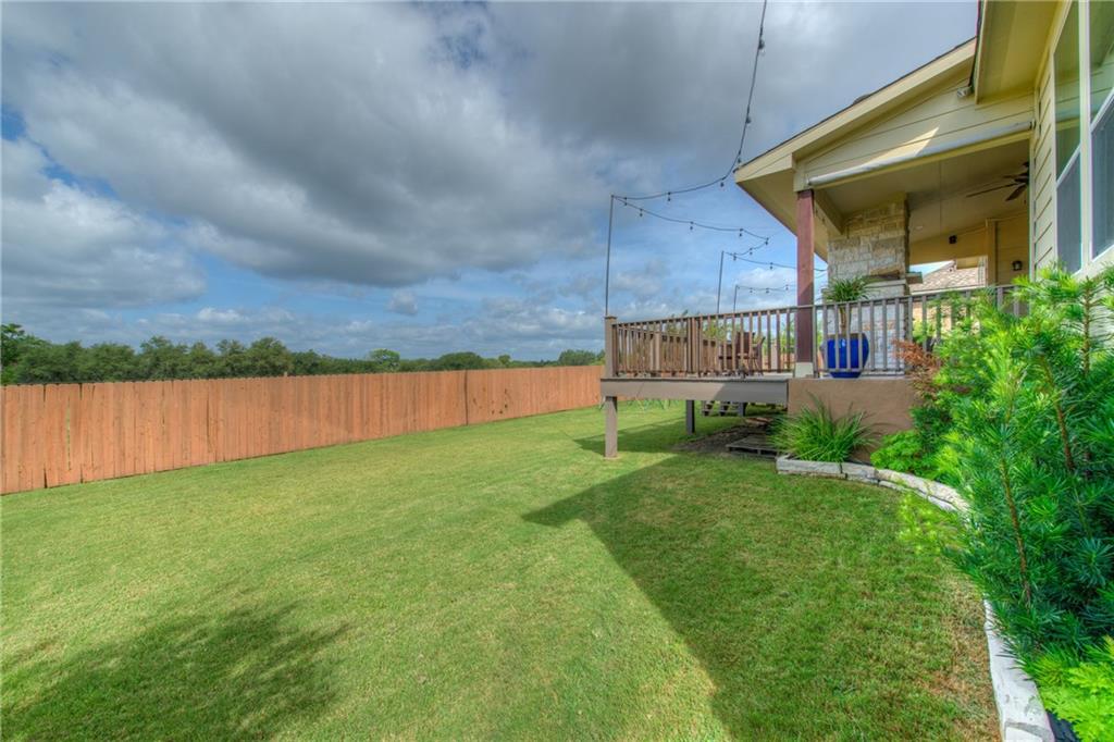 1511 Rimstone Drive Cedar Park, TX 78613 - Photo 32 of 40 a view of a backyard with plants and a lake view