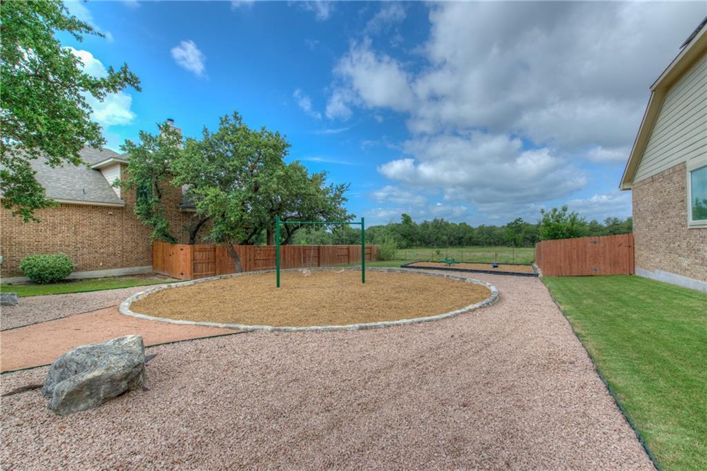 1511 Rimstone Drive Cedar Park, TX 78613 - Photo 39 of 40 a backyard of a house with lots of green space
