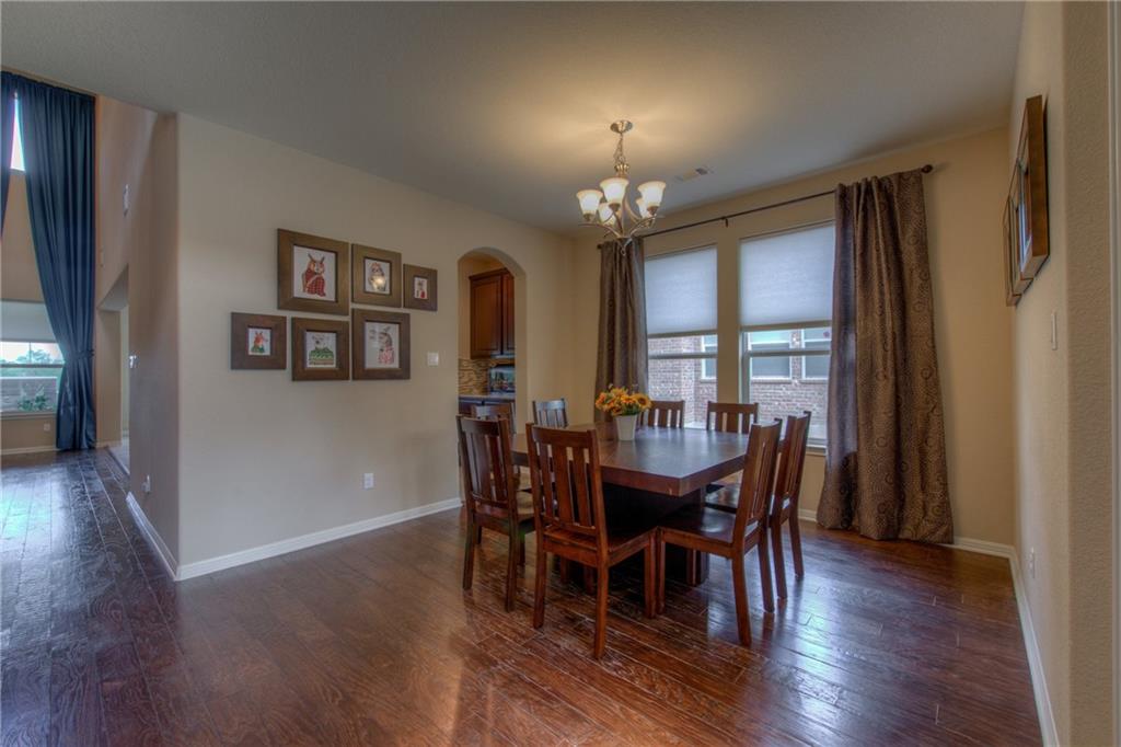 1511 Rimstone Drive Cedar Park, TX 78613 - Photo 6 of 40 a view of a dining room with furniture and wooden floor