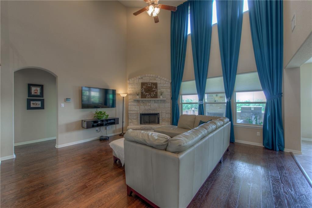 1511 Rimstone Drive Cedar Park, TX 78613 - Photo 8 of 40 a living room with furniture a large window and a flat screen tv