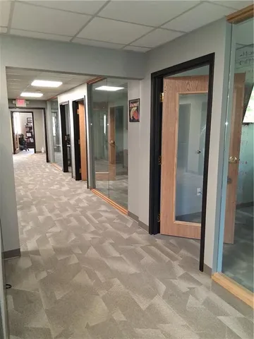 a view of a hallway with wooden shelves