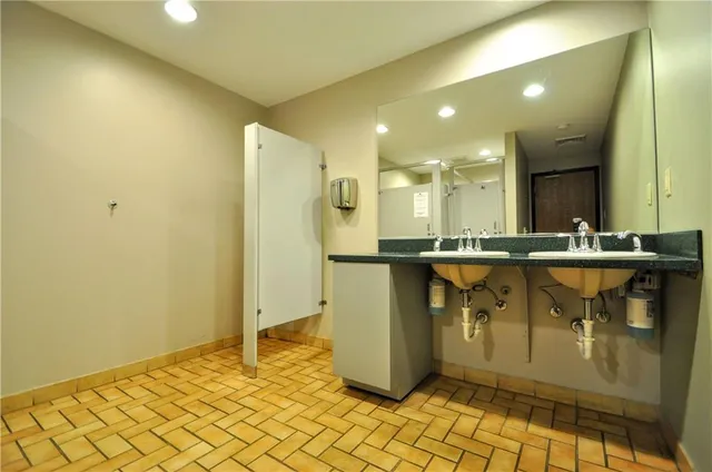 a view of kitchen with stainless steel appliances granite countertop cabinets and sink
