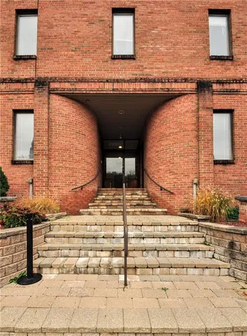 a view of a brick house with many windows