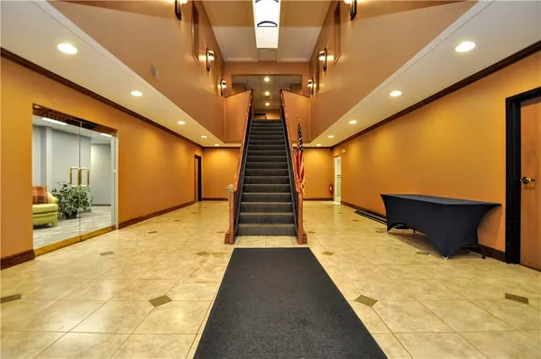 a view of entryway and hall with wooden floor