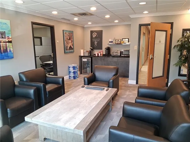 a living room with furniture and a dining table with kitchen view